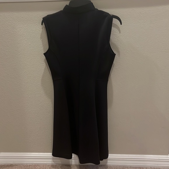 This is a black dress with a zipper and collar. It is an athletic material. - Picture 2 of 3